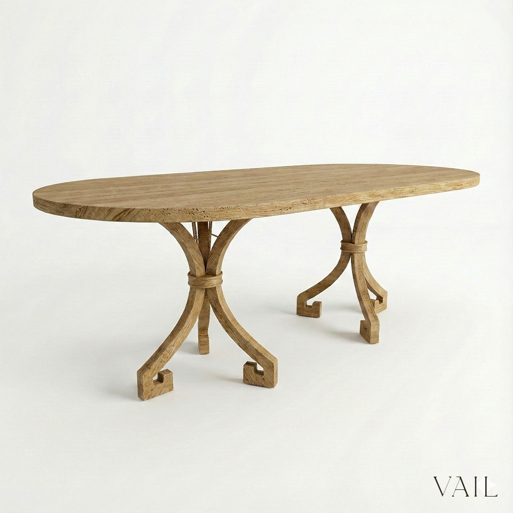 Wooden dining table with intricate legs on a white background, branded 'VAIL'.